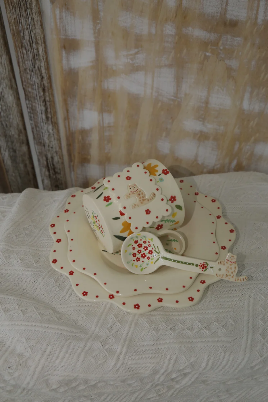Floral ceramic cup, scalloped saucer and spoon with small cat details