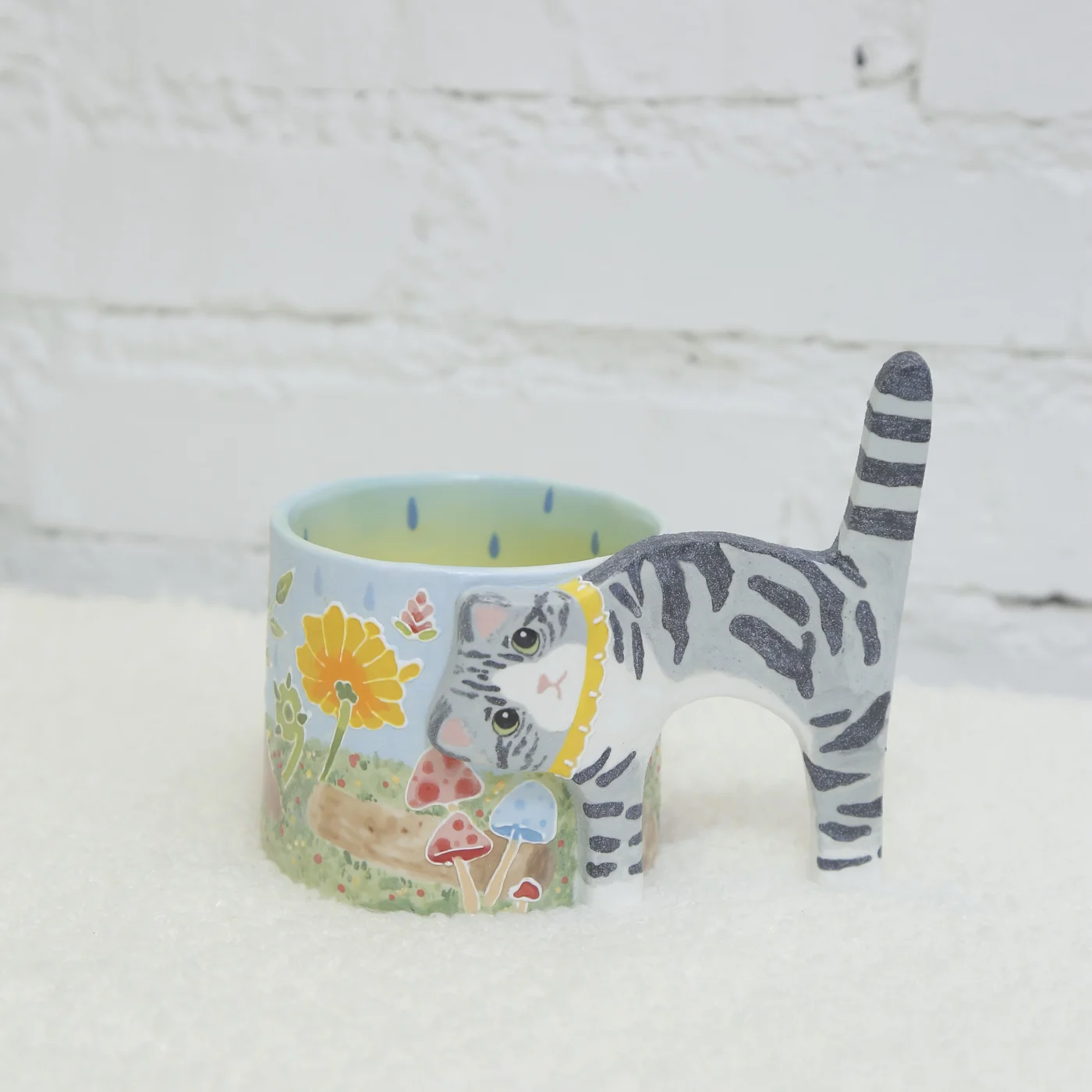 Striped cat ceramic cup with bright flowers and a blue interior